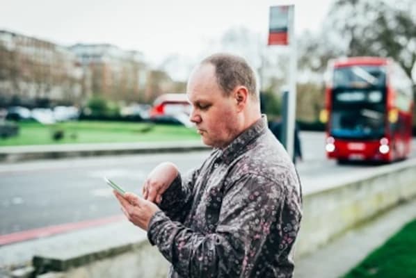 A person engaged in a creative, hands-on learning activity with a support worker.